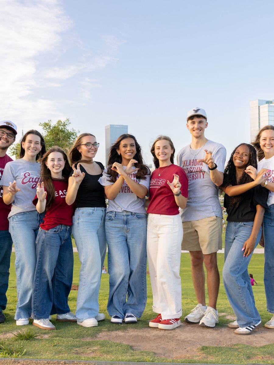 OC students standing in a group smiling at the camera