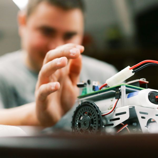 Electrical Engineering student with car