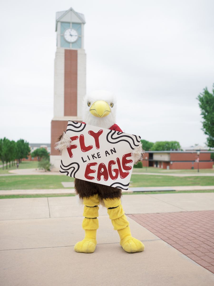 OC Eagle mascot (Ike) holding an Eagles sign