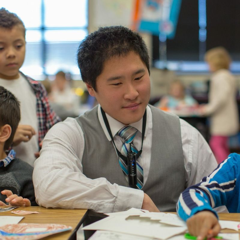 Teacher helping students