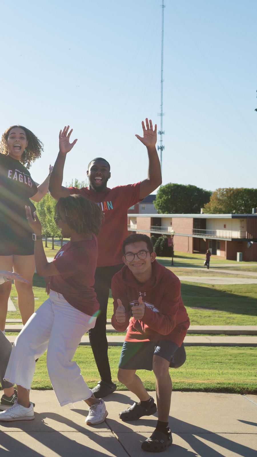 Jumping Students in Front of Clock Tower