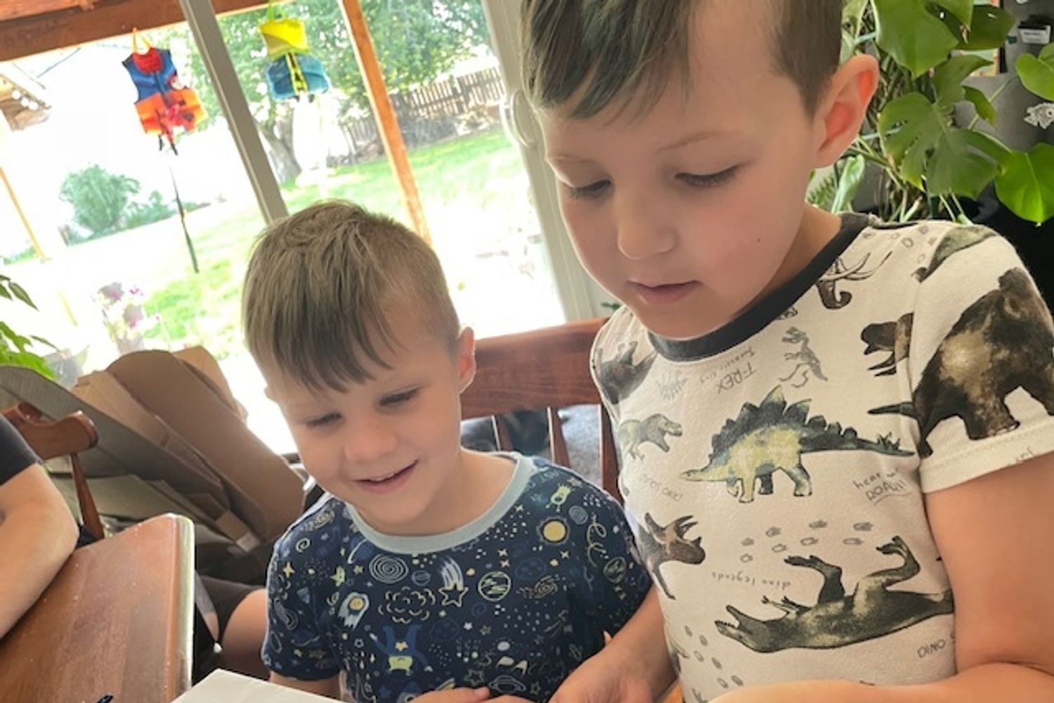 Phillip Heather Aske child receiving legacy gift reading letter with brother